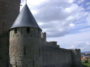 Imposing Ancient Fortress Walls Of Cité De Carcassonne Wallpaper