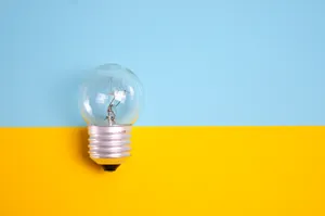 Incandescent Bulb On Yellow Surface Wallpaper