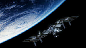 Incredible View Of The International Space Station (iss) Orbiting Above Earth. Wallpaper