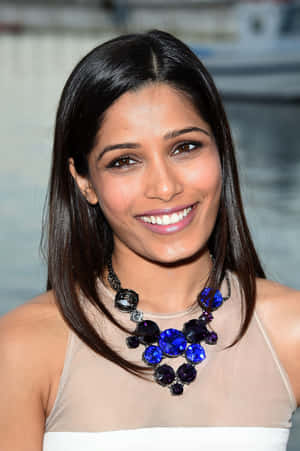 Indian Actress Freida Pinto Poses At An Event Wallpaper