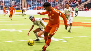 Indoor Soccer Action - Striking The Ball Wallpaper