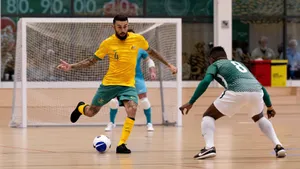 Indoor Soccer Match Dribbling Action.jpg Wallpaper