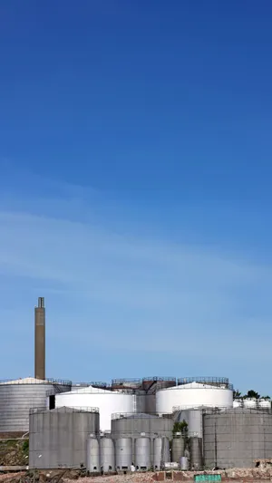 Industrial Storage Tanks Against Blue Sky.jpg Wallpaper