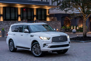 Infiniti Qx80 On The Road In The Countryside Wallpaper