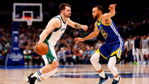 Intense Basketball Matchup Dribble Defense Wallpaper