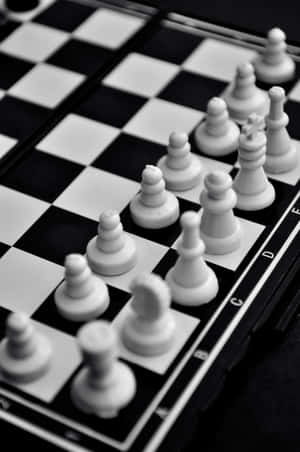 Intense Battle On A Black And White Chessboard Wallpaper