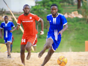 Intense Beach Soccer Match Wallpaper