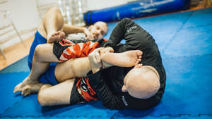 Intense Brazilian Jiu-jitsu Training Session Wallpaper