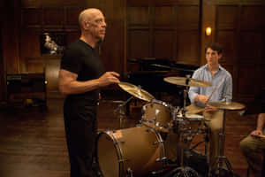 Intense Drumming Lesson Scene Wallpaper