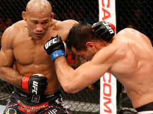 Intense Fight Moment - Ronaldo Souza Using Back Head Punch In A Mma Fight Wallpaper