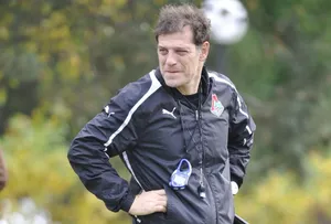 Intense Focus Of A Football Coach On The Field Wallpaper