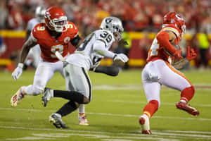 Intense Football Action Raidersvs Chiefs Wallpaper