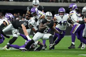 Intense Football Action Raidersvs Vikings Wallpaper