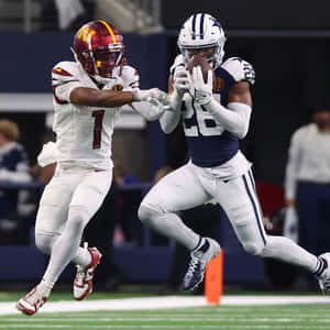 Intense Football Catch Attempt Wallpaper