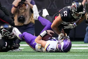 Intense Football Tackle Moment Wallpaper