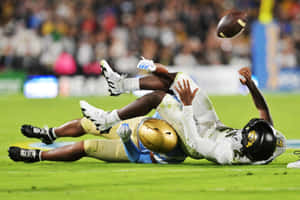 Intense Football Tackle Moment Wallpaper