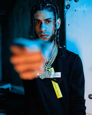 Intense Gaze Man Holding Gun Wallpaper