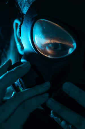 Intense_ Gaze_ Through_ Gas_ Mask Wallpaper