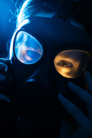 Intense_ Gaze_ Through_ Gas_ Mask Wallpaper