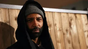 Intense_ Man_in_ Hoodie_and_ Beanie Wallpaper