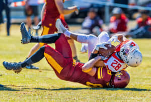 Intense Moment Of A Football Tackle Wallpaper