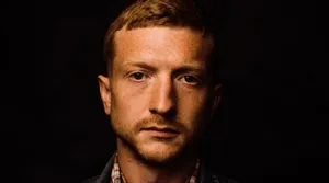 Intense Portraitof Manwith Shadowed Background Wallpaper