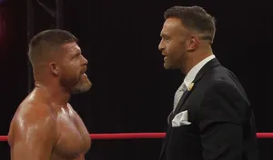 Intense Staredown Wrestling Ring Wallpaper