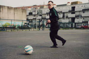 Intense Street Soccer Match In Progress Wallpaper