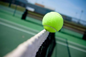 Intense Tennis Match Under Bright Lights Wallpaper