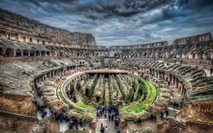 Interior Of The Colosseum Beneath A Dark Sky Wallpaper