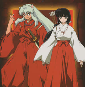 Inuyasha And Kikyo Sharing An Emotional Moment Under A Cherry Blossom Tree. Wallpaper