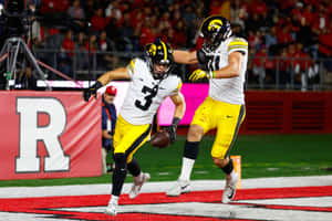 Iowa Hawkeyes Football Players Celebrating Wallpaper
