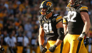 Iowa Hawkeyes Football Players On Field Wallpaper