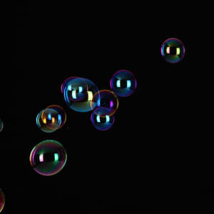 Ipad Pro Floating Bubbles On Black Wallpaper