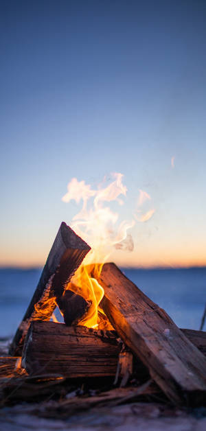 Iphone Fire Wood By The Sea Wallpaper