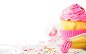 Irresistibly Cute Cupcake With Rainbow Sprinkles Wallpaper