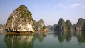 Islands Reflecting On Halong Bay's Water Wallpaper