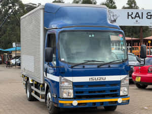 Isuzu Elf Blue Truck Parked Wallpaper