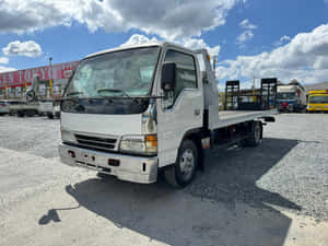 Isuzu Elf Flatbed Truck Parked Wallpaper