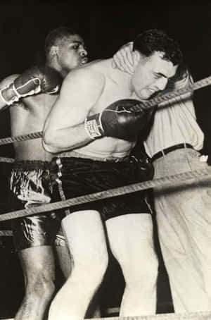 Italian Boxer Primo Carnera Holding On To The Ropes Wallpaper