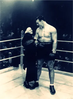 Italian Professional Boxer Primo Carnera Looking At Jean Harlow Wallpaper