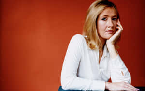 J.k. Rowling Posing With Her Books Wallpaper