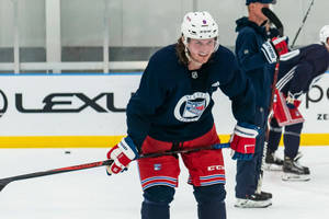 Jacob Trouba Smiling While Leaning Forward During Training Wallpaper