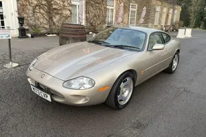 Jaguar X K Coupe Parked Outdoors Wallpaper