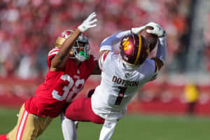 Jahan Dotson Catching Football During Game Wallpaper