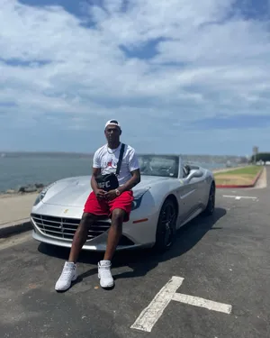 Jamahal Hill Sitting On Hood Of Ferrari Wallpaper