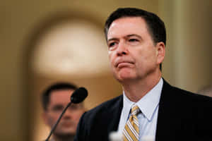 James Comey Serious Expression During Hearing.jpg Wallpaper