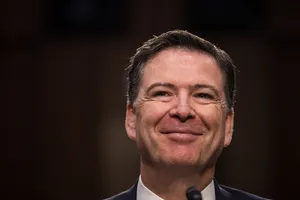 James Comey Smiling During Testimony Wallpaper