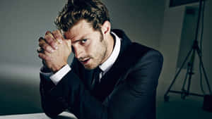 Jamie Dornan Posing In A Stylish Attire Wallpaper