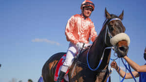 Jamie Kah In Action During A Horse Racing Event Wallpaper